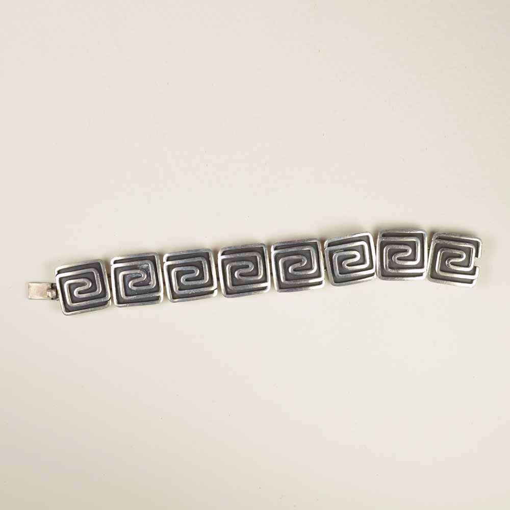 A bracelet with a black and white design on it.