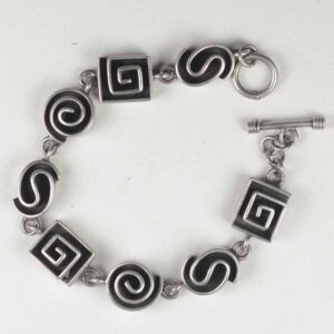 A bracelet with black and white swirls on it.