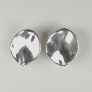 A pair of silver earrings with a black and white pattern.