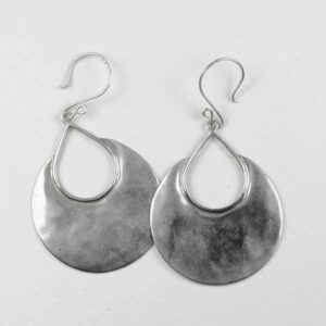 A pair of silver earrings hanging on the side.