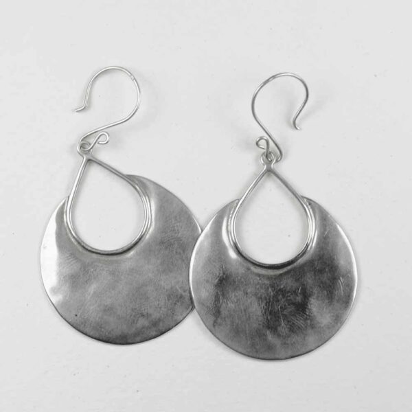 A pair of silver earrings hanging on the side.