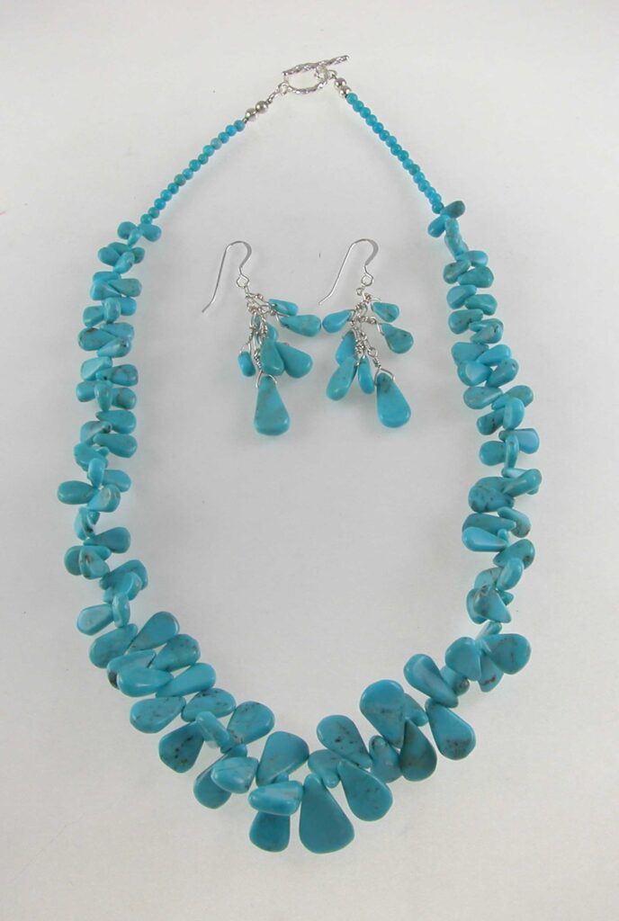 A necklace and earrings set made of turquoise.