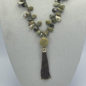 A necklace with a tassel and beads on it