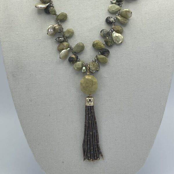 A necklace with a tassel and beads on it