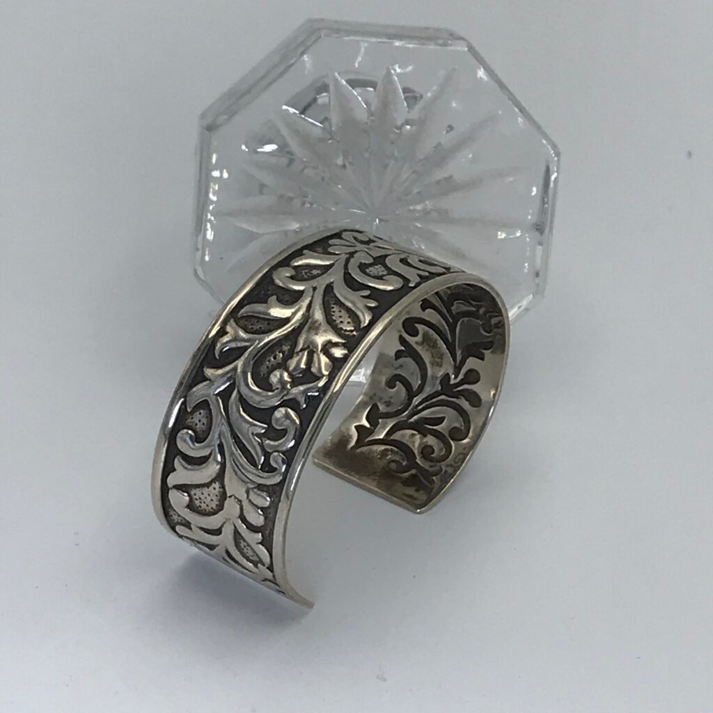 A silver ring with a glass background