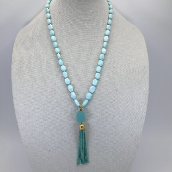 A necklace with a long tassel and blue beads