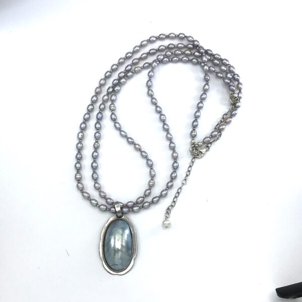 A necklace with a large stone on it