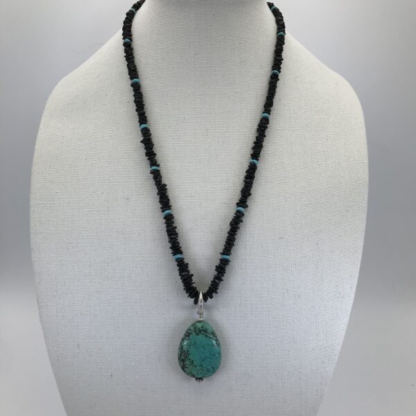 A necklace with a turquoise pendant on it