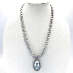 A necklace with a large blue stone on it