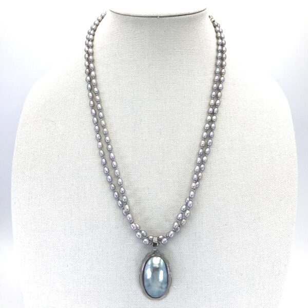 A necklace with a large blue stone on it