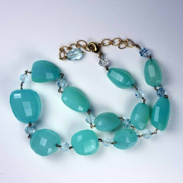 A necklace of blue beads and clear crystal.