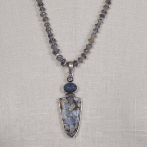 A necklace with a blue stone and a silver pendant.