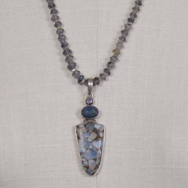 A necklace with a blue stone and a silver pendant.