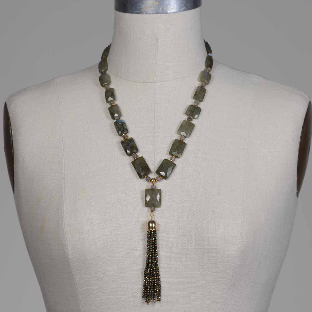 A necklace is shown on the mannequin.