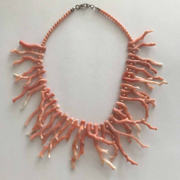 A necklace made of coral and chain.