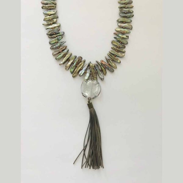 A necklace with a tassel and a long chain.