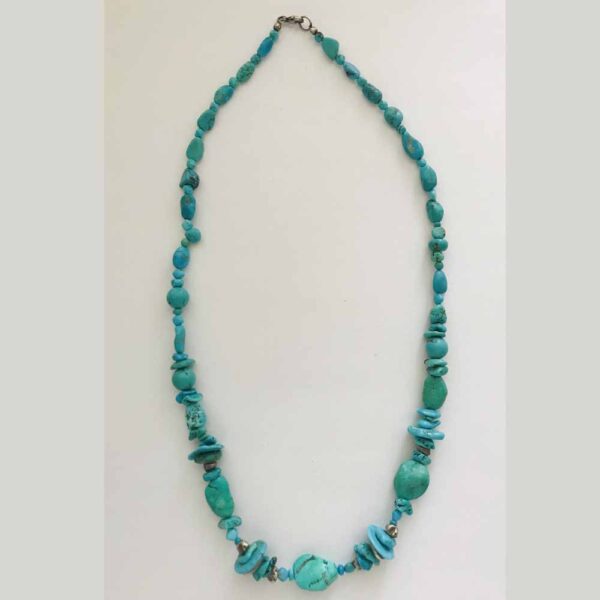 A necklace of turquoise and green stones.