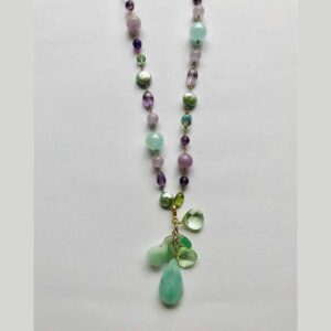 A necklace with green beads and a green stone.