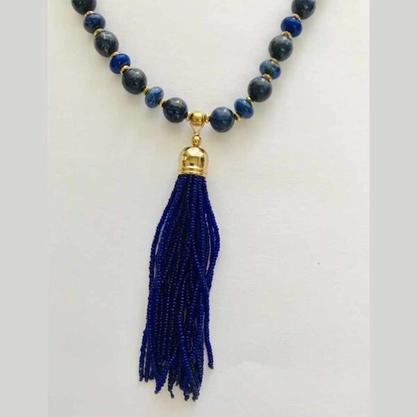 A necklace with blue beads and a tassel.