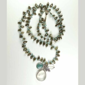 A long necklace with a blue stone and a clear glass bead.