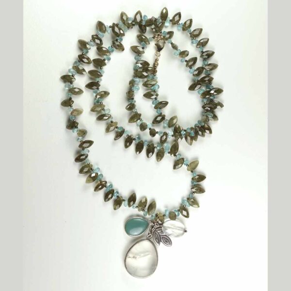 A long necklace with a blue stone and a clear glass bead.