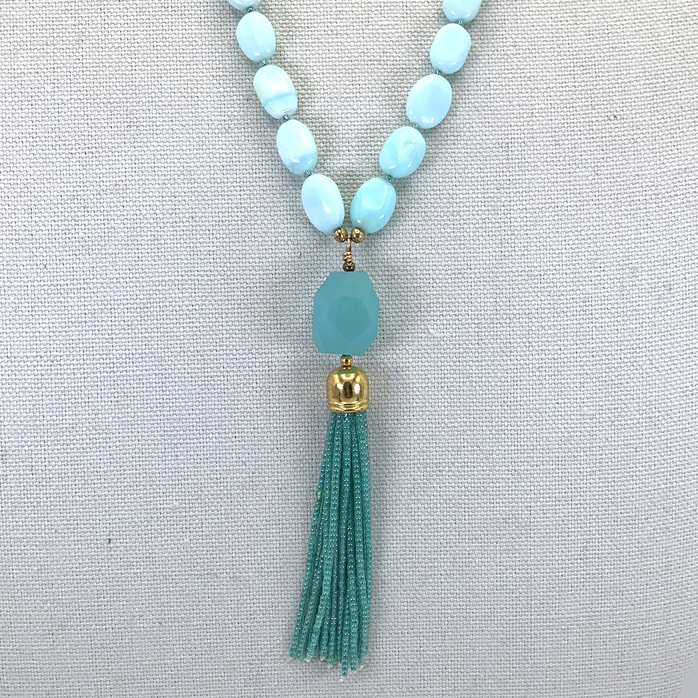 A necklace with a blue bead and tassel.