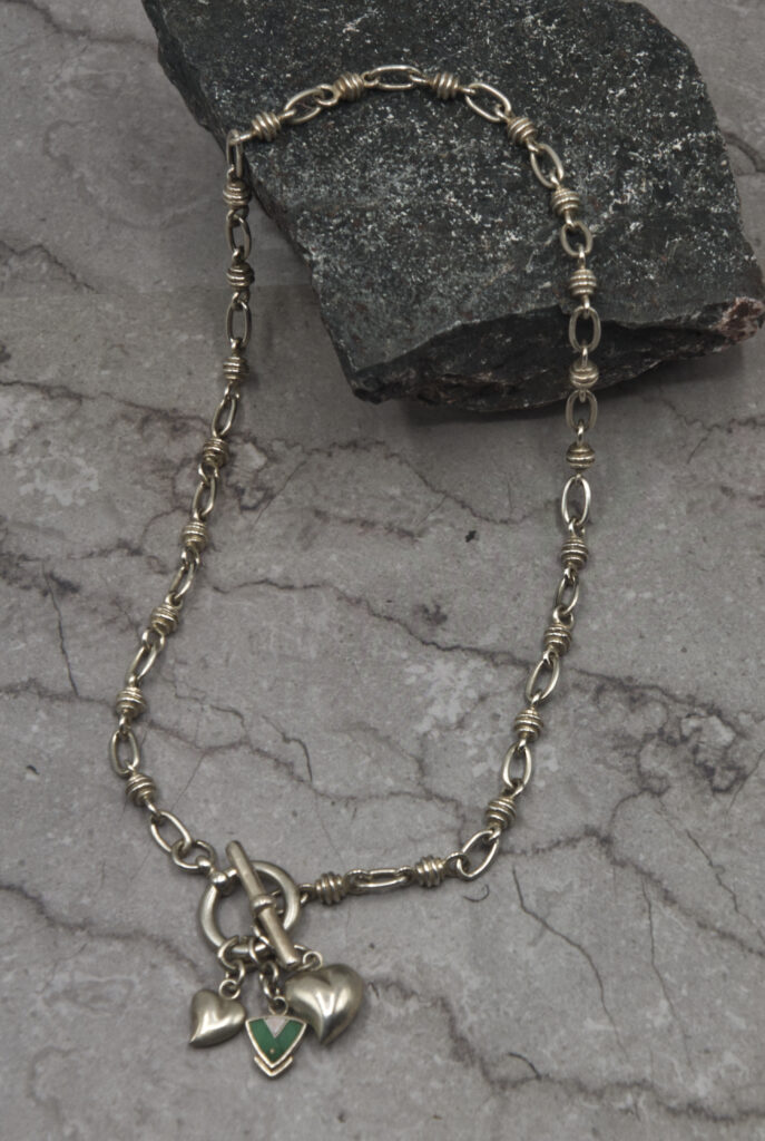 A chain link necklace with an anchor charm.