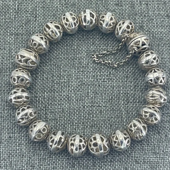 A silver bracelet with black and white beads